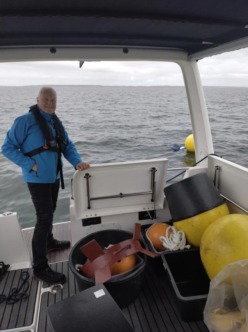 Dines Juhl Barsøe conducting water monitoring from a boat.